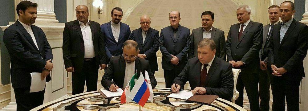 Iranian and Russian Officials attend the signing ceremony for two oil deals in Moscow on Oct. 4.