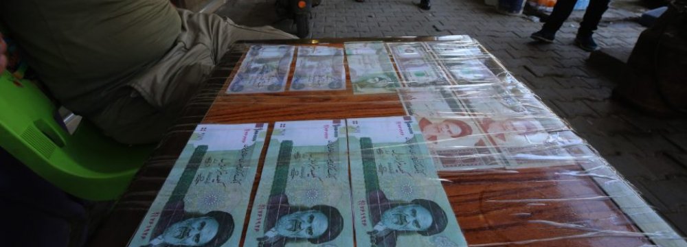 An Iraqi peddler displays Iranian currency for sale in the capital Baghdad on Aug. 9. 
