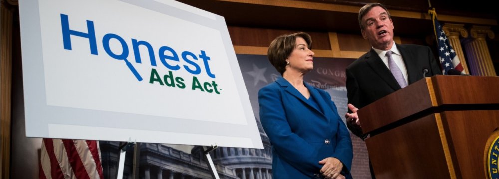 Democratic Senators Amy Klobuchar (L) and Mark Warner introduced the Honest Ads Act, in Washington, D.C. on Oct. 19.