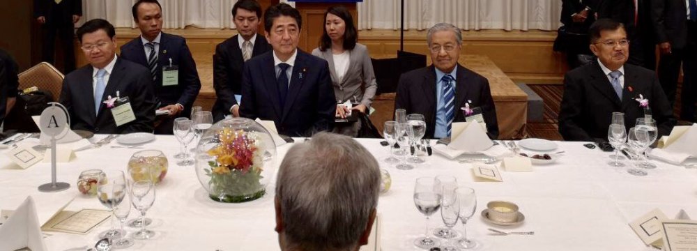 Prime Minister Shinzo Abe (C) says the funds will be made available over the next three years.