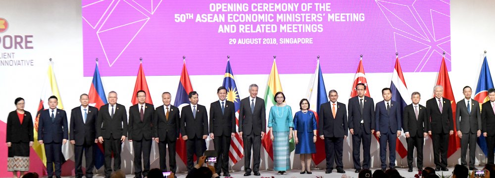 ASEAN members gather for a family photo at the opening of 50th ASEAN Economic Ministers Meeting in Singapore on August 29.