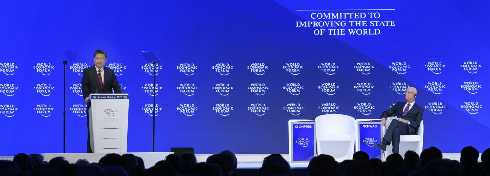 China’s President Xi Jinping (L) delivers a speech on the opening day of the World Economic Forum, on January 17, in Davos. WEF executive chair Klaus Schwab in on the right.