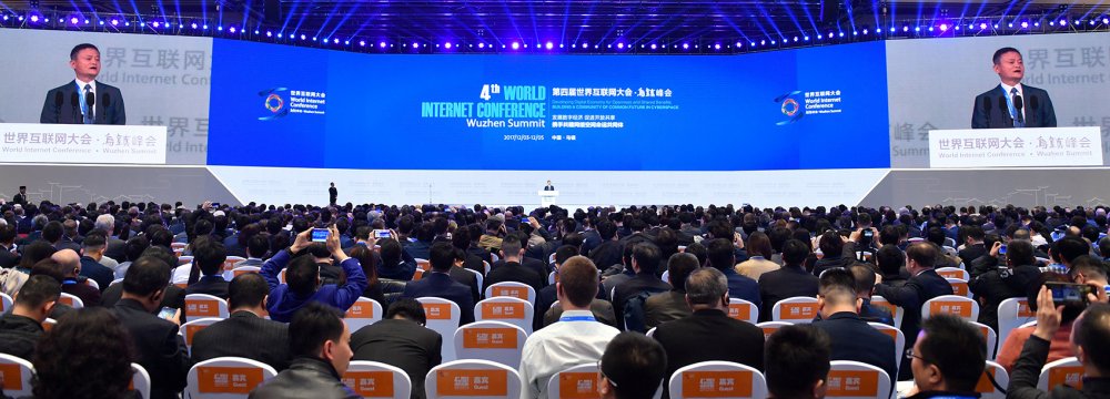 Delegates listen as Alibaba Group Executive Chairman Jack Ma speak during the opening ceremony of the 4th World Internet Conference  in Wuzhen in eastern China on December 3.