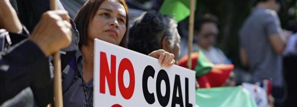 A woman protests a planned coal-fired plant  in southern Thailand.