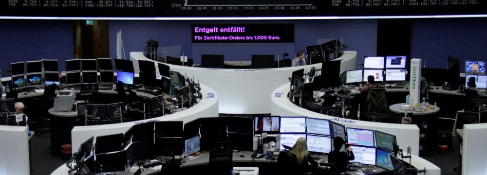 Traders in front of the German share price index, DAX board, at the stock exchange in Frankfurt. 