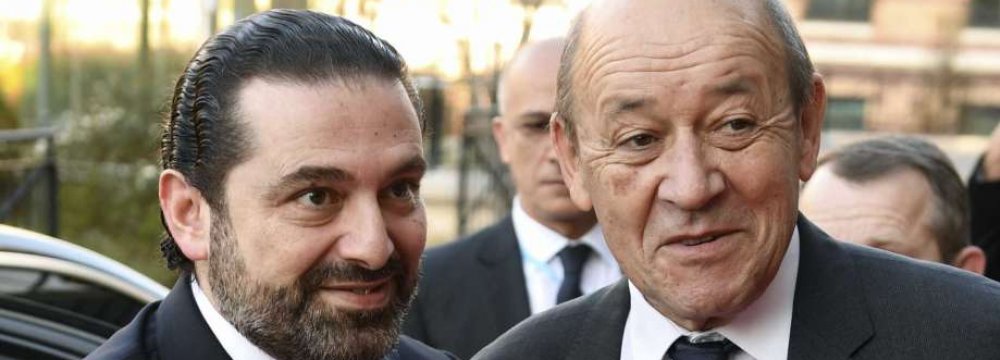 Saad Hariri (L) and French FM Jean-Yves Le Drian at the Cedar Conference in Paris on Friday.