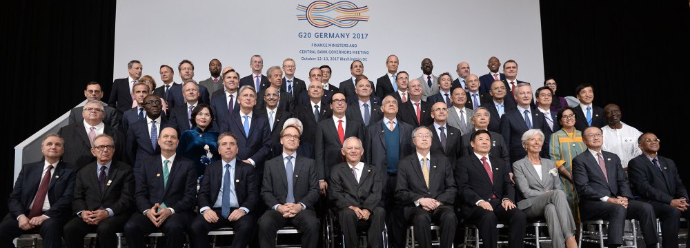 G20 Finance ministers pose for a group photo at the IMF headquarters during the WB/IMF Annual Meetings in Washington, DC, Friday.
