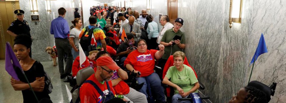 Protesters gathered in the Capitol Hill hallway while during a Senate committee hearing on healthcare.