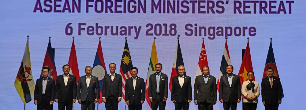 Foreign ministers pose for a group photo at the ASEAN Foreign Ministers’ Meeting retreat in Singapore on February 6.  