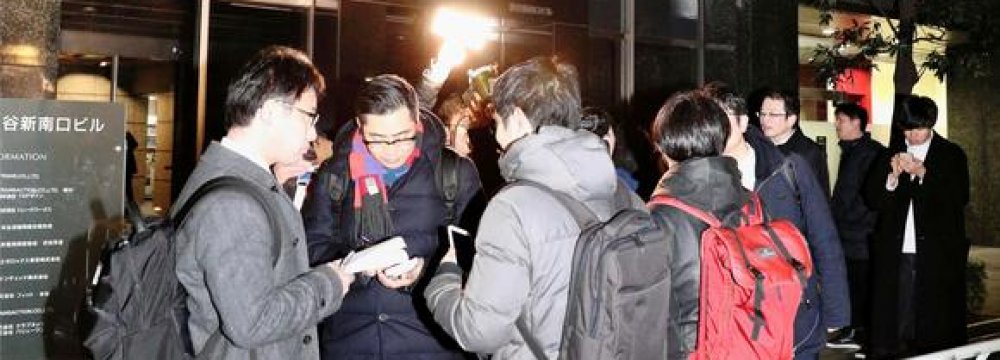 Concerned users outside Coincheck headquarters  in Tokyo on Friday.
