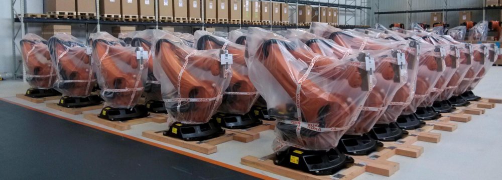 A gauge for consumer services sales growth rose to a 21-month high. The picture shows industrial robots ready for sale.