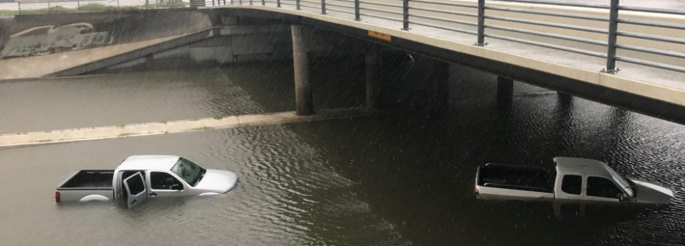 Vehicles half submerged in flood waters under a bridge in the aftermath of hurricane Harvey, in Houston, Texas, August 27.