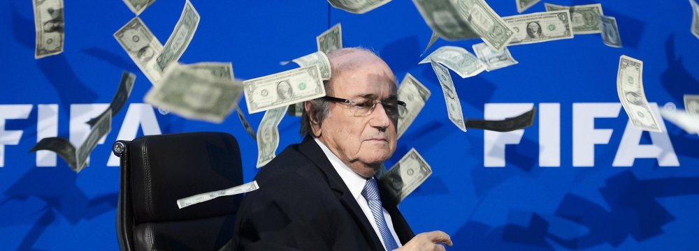 Sepp Blatter was showered with fake money by British comedian Lee Nelson at 2015 FIFA press conference, Zurich. “Sepp, this is for North Korea in 2026” said Nelson while throwing money to blatter, accusing him of bribery in FIFA.
