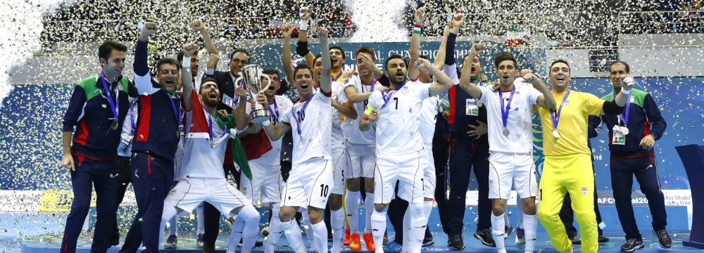 Iranian players and coaching team celebrate winning their second consecutive title. 