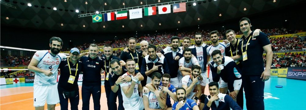 Iranian players and coaches celebrate the victory over Japan.