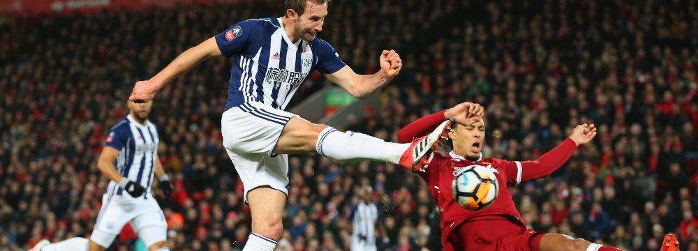 Craig Dawson of West Bromwich Albion takes a shot past Virgil van Dijk of Liverpool in the build up to an own goal scored by Joel Matip of Liverpool.
