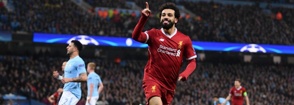 Liverpool’s Mohamed Salah rejoices scoring against Manchester City.