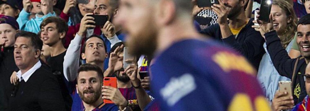 Reza Parastesh takes a photo of Messi during the match between Barcelona and Malaga at Nou Camp on Oct. 21.