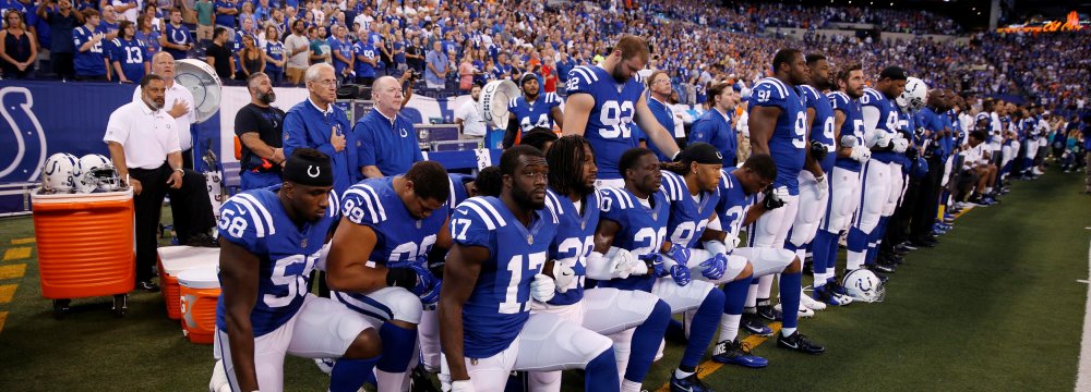 Indianapolis Colts players kneel during the playing of the national anthem at Lucas Oil Stadium last September.