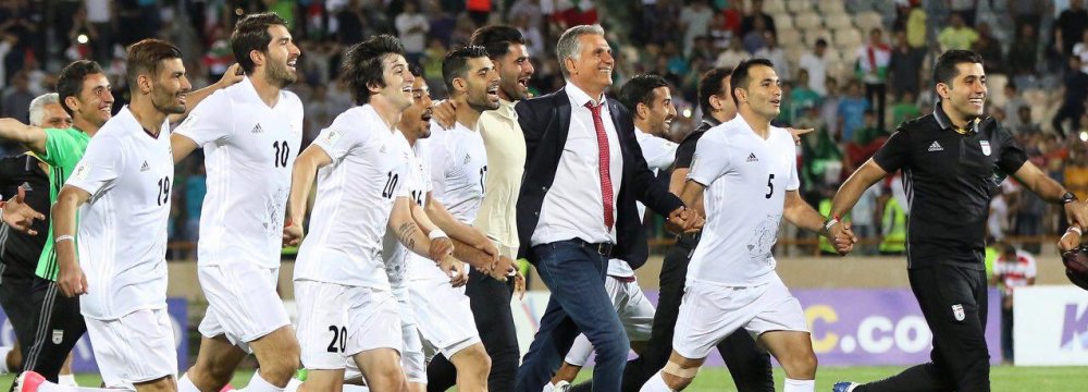 Team Melli members celebrate qualification for the 2018 FIFA World Cup after beating Uzbekistan 2-0 in the third round of World Cup Qualifiers at Tehran’s Azadi Stadium on June 12, 2017.