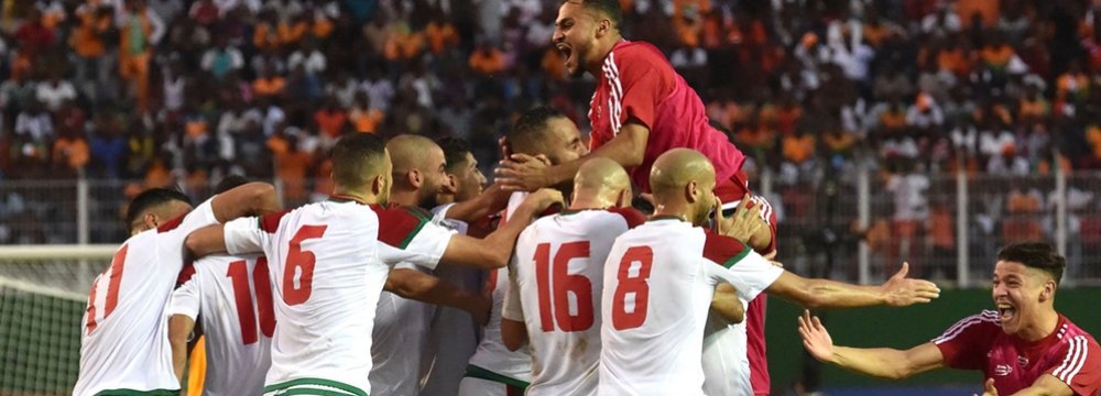 Morocco national team players celebrate their first World Cup appearance after 20 years.