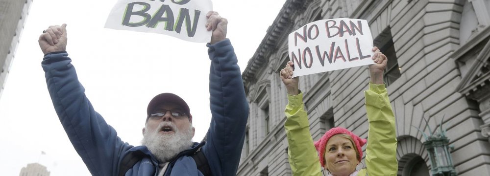 Protesters hold signs outside the appeals court in San Francisco on Feb. 7.