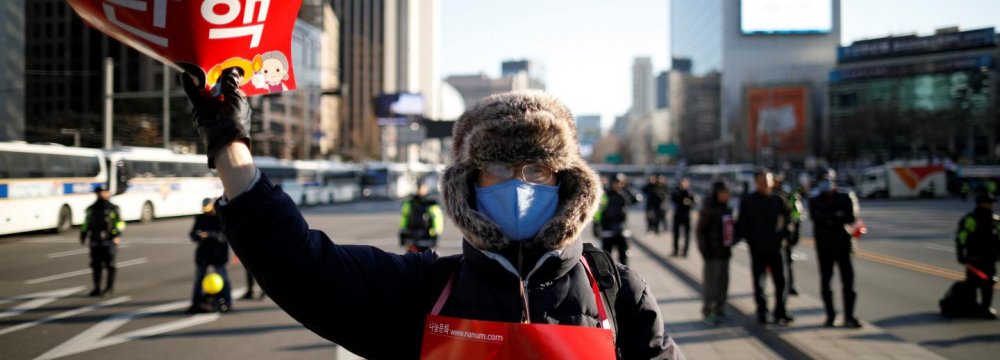 A protester, whose sign reads “Impeachment”, attends a rally in Seoul, South Korea, on Feb. 25.