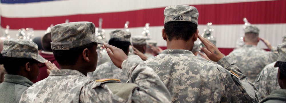 Soldiers salute the US flag.