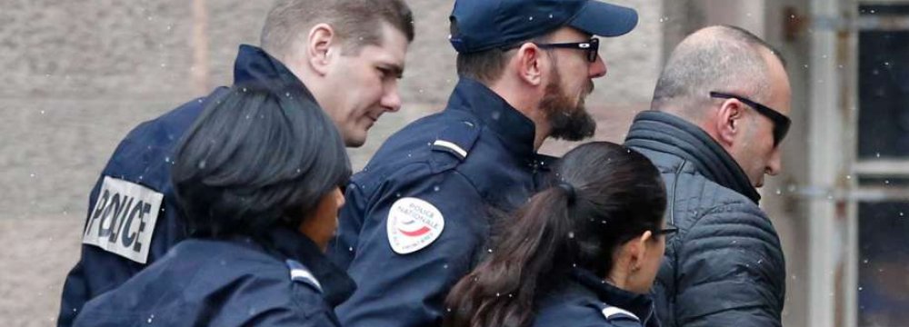 Former Kosovo prime minister Ramush Haradinaj,  is rushed by police officers inside the Colmar courthouse, eastern France, on Jan. 5.