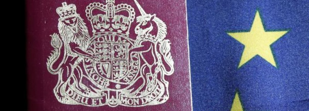 A British passport is pictured in front of an European Union flag in this photo illustration.