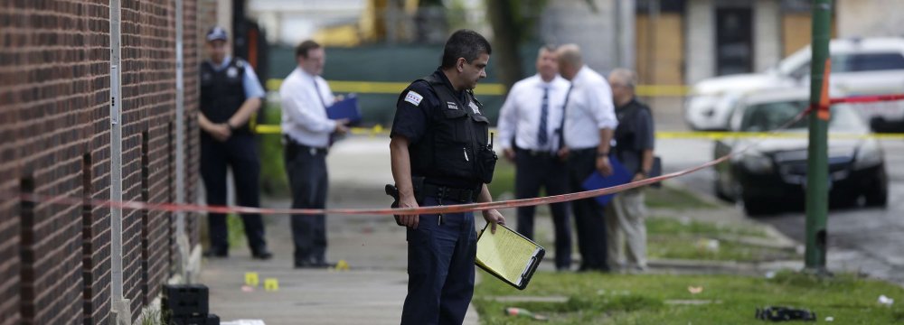 Chicago Police officers and detectives investigate  a shooting where multiple people were shot on Aug. 5.