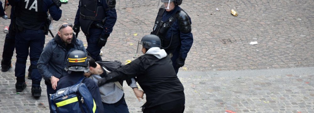A screen shot from a video showing Alexandre Benalla wearing a police helmet and manhandling a protester in Paris in May.