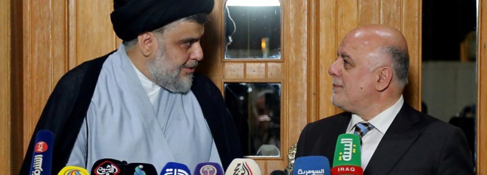 Iraqi Prime Minister Haider al-Abadi (R) attends  a press conference with Iraqi Shia cleric and leader Muqtada al-Sadr in Najaf on June 23.