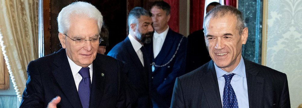 Former senior IMF official Carlo Cottarelli (R) arrives for a meeting with the Italian President Sergio Mattarella  at Quirinal Palace in Rome, Italy on May 28.