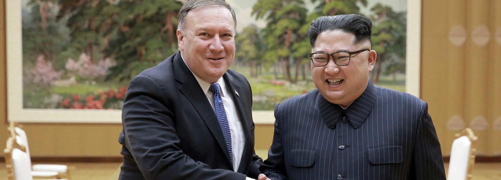 US Secretary of State Mike Pompeo (L) shakes hands with North Korean leader Kim Jong-un during  a meeting at Workers’ Party of Korea headquarters in Pyongyang, North Korea on May 9.