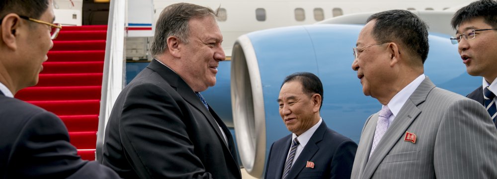 US Secretary of State Mike Pompeo (L) is greeted by North Korean Director of the United Front  Department Kim Yong-chol (C) and North Korean Foreign Minister Ri Yong-ho (R) as he arrives  at Sunan International Airport in Pyongyang on July 6.