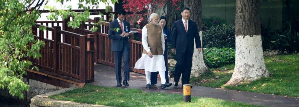 India’s Prime Minister Narendra Modi (L) speaks with Chinese President Xi Jinping at the East Lake in Wuhan, China on April 28.