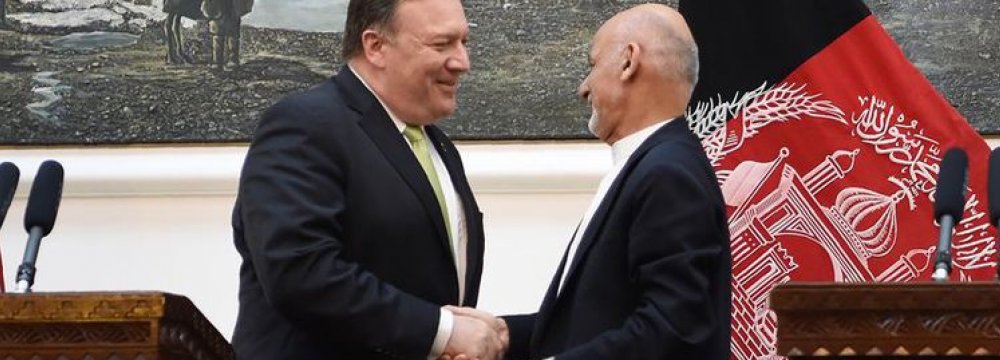US Secretary of State Mike Pompeo (L) and Afghan President Ashraf Ghani shake hands after a press conference at the presidential palace in Kabul on July 9.