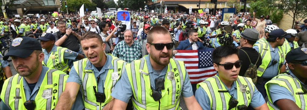 Police escort far-right demonstrators during a rally at Lafayette Park  opposite the White House, on August 12.