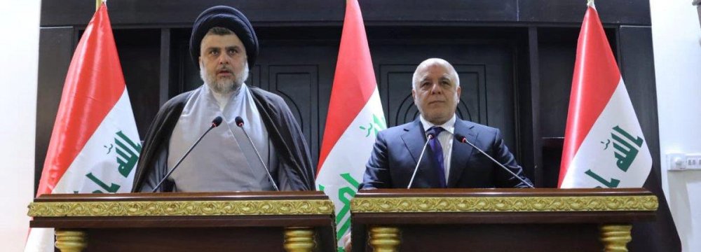 Iraqi Shia cleric Muqtada al-Sadr (L) speaks during a news conference with Iraqi Prime Minister Haider al-Abadi in Baghdad, Iraq on May 19.