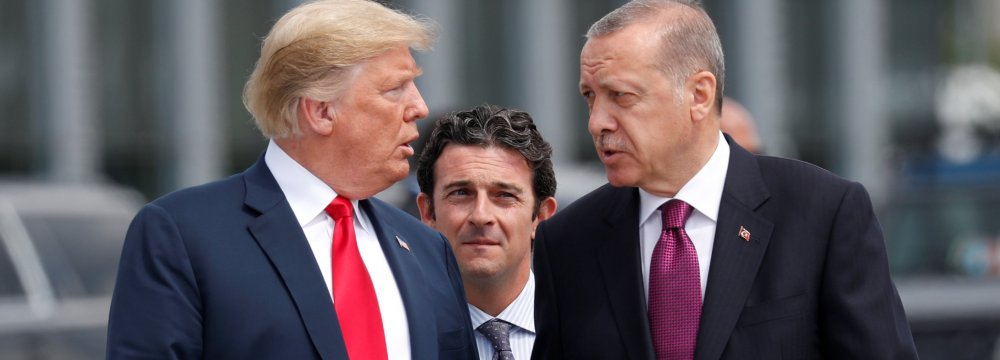 US President Donald Trump (L) and Turkish President Recep Tayyip Erdogan talk  at the start of the NATO summit in Brussels, Belgium, on July 11.