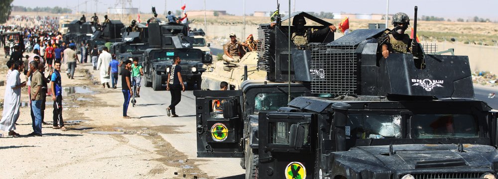 Iraqi forces arrive in the first neighbourhood on the southern outskirts of Kirkuk on October 16. (Photo: AFP)