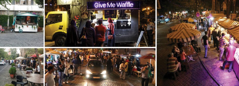 Repurposed vans and motorhomes have popped up on the fringes of the cobblestoned street, serving passersby drinks and food.