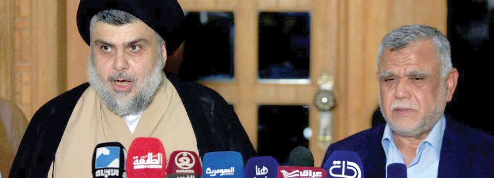 Moqtada al-Sadr speaks during a news conference with the Leader of the Conquest Coalition Hadi al-Amiri, in Najaf, Iraq on June 12.