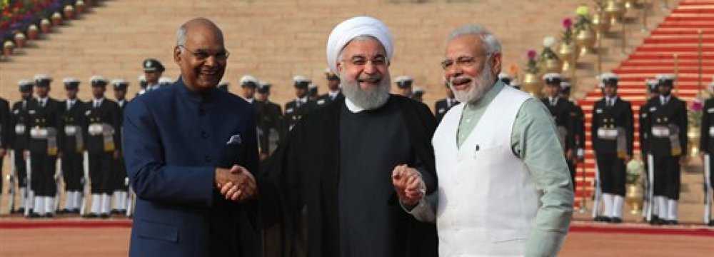Iranian President Hassan Rouhani (C) holds the hands of Indian President Ram Nath Kovind (L) and Prime Minister Narendra Modi during a ceremonial reception in New Delhi, India, Feb. 17. (AP Photo by Manish Swarup)