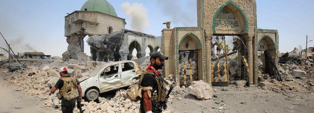 Members of Iraqi Counter Terrorism Service sift through the ruins of the Grand al-Nuri Mosque in Mosul, Iraq June 29.