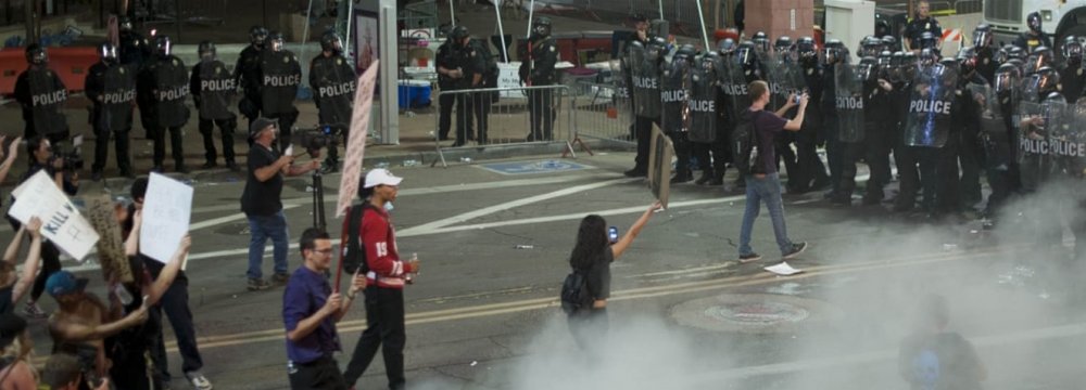 Three people were arrested in skirmishes between anti-Trump protesters and police.