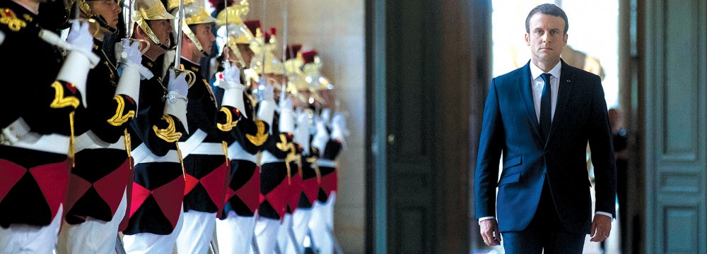 French President Emmanuel Macron walks through the Galerie des Bustes for a special gathering of both houses of parliament outside Paris, on July 3.