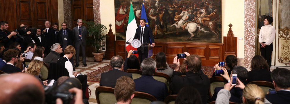 Italy’s Prime Minister Matteo Renzi announces his resignation during a press conference at the Palazzo Chigi following the results of the vote for a referendum on constitutional reforms, on December 5, in Rome. 