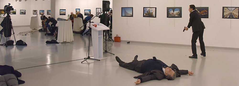 The gunman Mevlut Mert Altintas is seen at the scene of the assassination next to the body of the Russian ambassador, Andrey Karlov.
